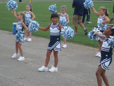 Kasen cheering at a Coffee County Youth football game